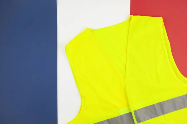 Yellow vests, as a symbol of protests in France. Yellow jacket with the flag of France