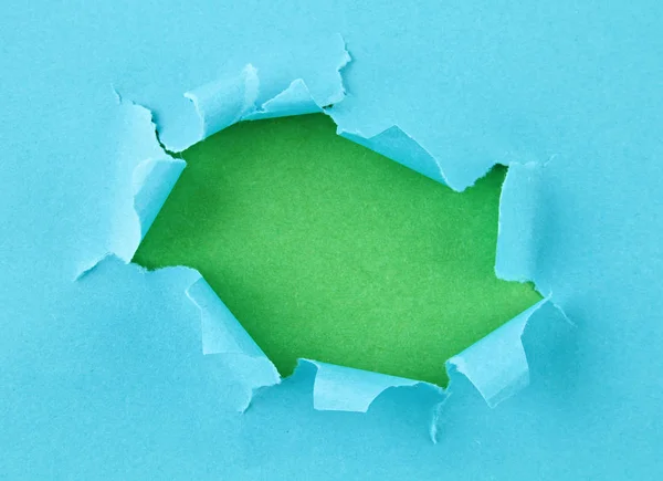 Torn colored paper, hole in the sheet of paper
