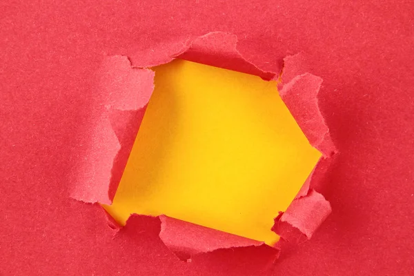 Torn colored paper, hole in the sheet of paper