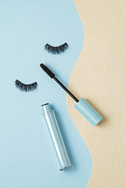 Top view of Mascara brush over the blue background