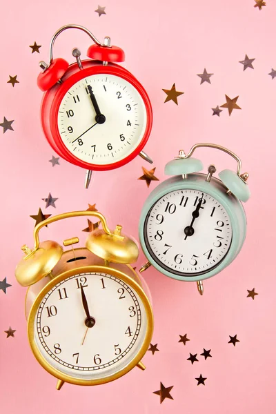 Collection of bright colorful alarm clocks over the pink background — ストック写真