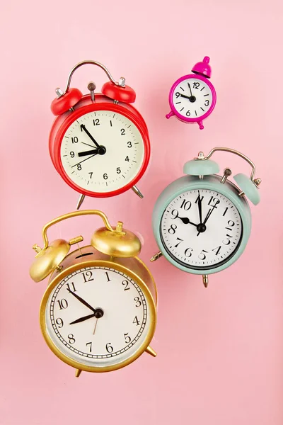 Collection of bright colorful alarm clocks over the pink backgro — Stock Photo, Image