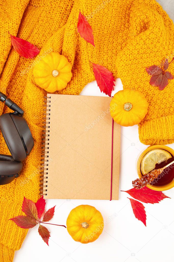 Flat lay autumn composition with fall leaves, hot cup of tea and