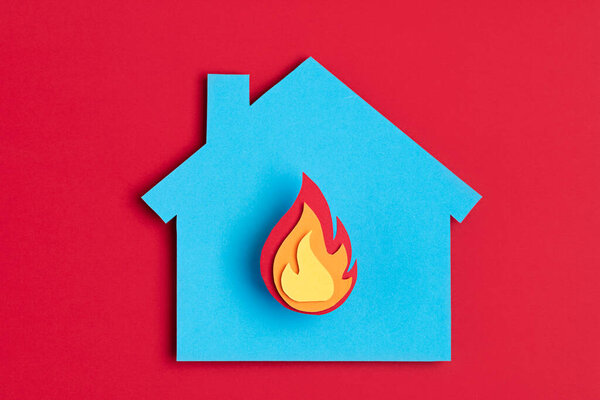 Papercut house with fire inside. Home insurance, security, safety, damage, accident prevention concept