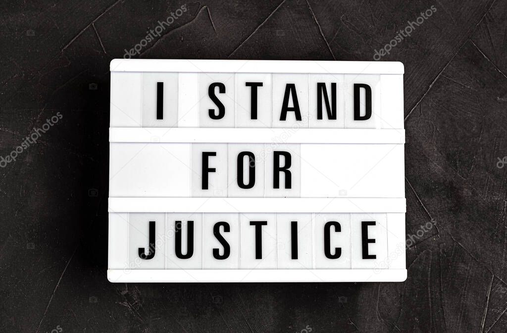 I stand for justice text on light box over dark background