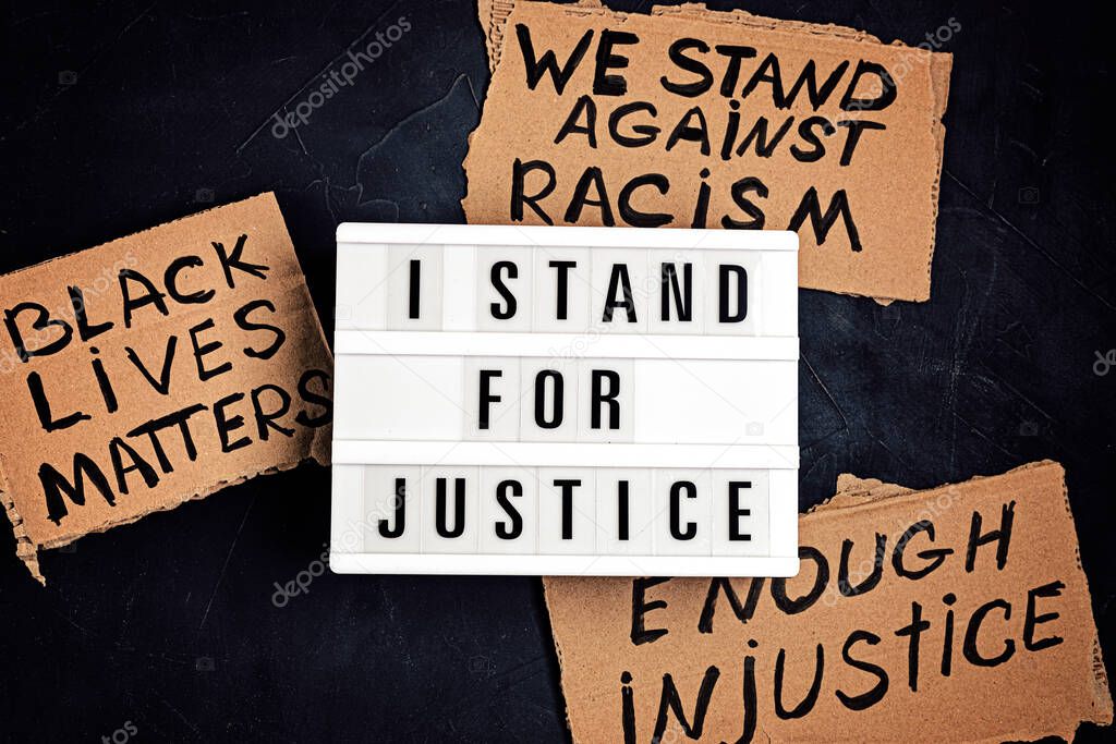 I stand for justice text on light box and other anti racism slogans over dark background