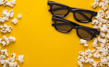 Yeni 3d gözlük ve sinema arka plan sarı arka plan kavramı üzerinde patlamış mısır