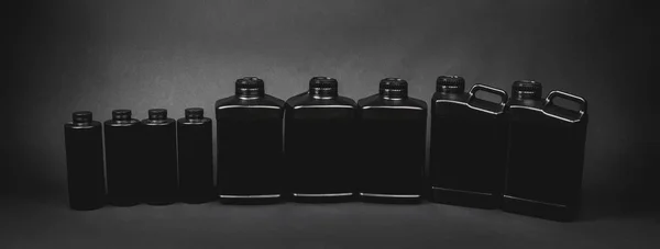 Black Plastic Cans Jars Black Background Mockup — Stock Photo, Image