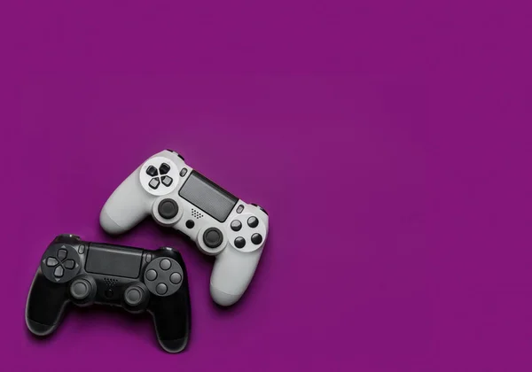 紫色の背景に黒と白のゲームパッド ゲームのコンセプト — ストック写真