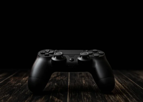 Gamepad negro moderno sobre un fondo oscuro. Concepto de juego con cop — Foto de Stock