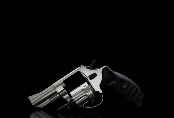 Silver pistol revolver on a black back. Low key photography. Wea — Stock Photo, Image