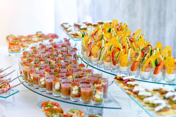 A variety of snacks, canapes and sandwiches on the table. — Stock Photo, Image