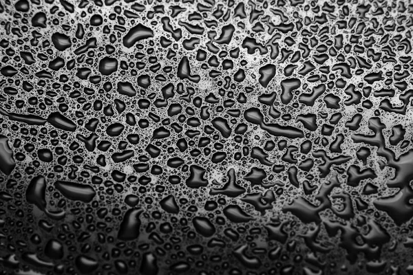 Shiny water drops on a dark glass. Water drops on black surface. — Stock Photo, Image