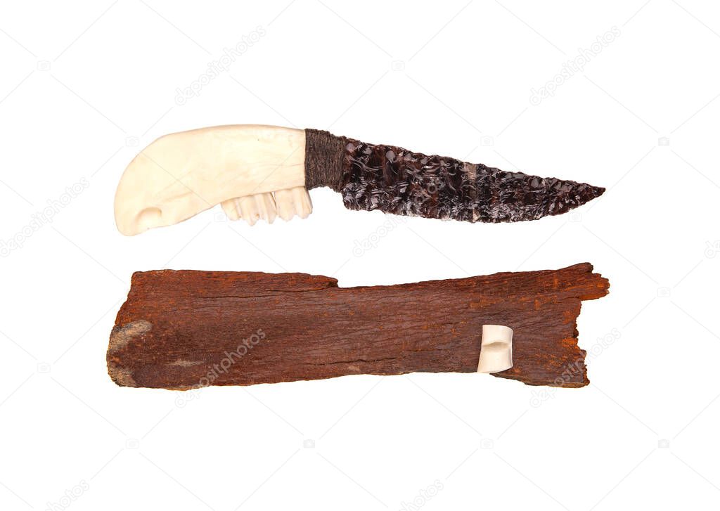 Obsidian knife with bone handle isolate on a white background. Prehistoric weapon made of volcanic glass.