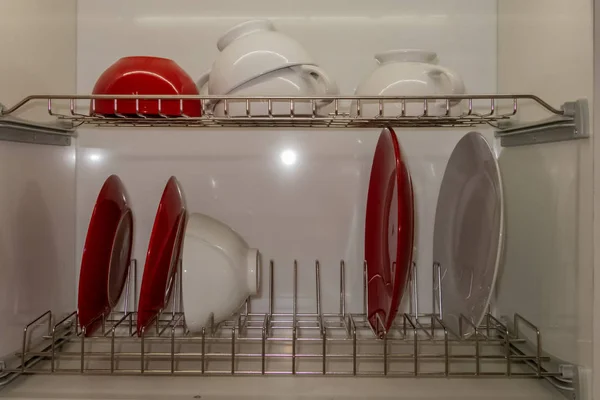 Metal drying for dishes of two sections, built into the kitchen box.