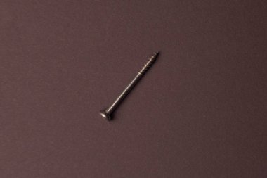 Kahverengi bir arka plan üzerinde bir iç altıgen ile vida. Yaratıcı vintage arka plan.