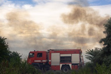 Yangın motorunda bir itfaiye, bir orman ateşi söndürür. Rus-itfaiye arabası ve Odessa arabada yazıtlar. 2019.06. 08. Odessa 'da. Ukrayna.