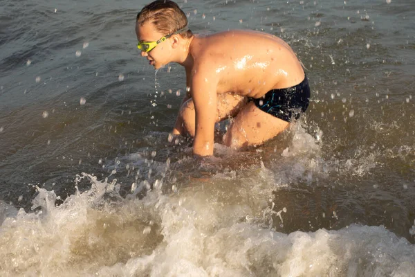一名身穿绿色泳镜的10岁男孩在近岸海域游泳 — 图库照片