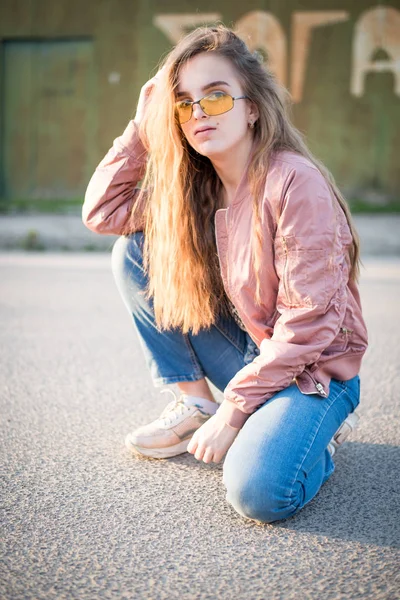 Young beautiful woman on the street. Emotions, people, beauty and lifestyle concept. Street photo of young woman wearing stylish casual clothes. Female fashion concept. Cute teenage girl.
