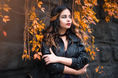 Genç kadın rahat kıyafetler ve siyah deri ceket kentsel şehir arka plan sonbahar portre üzerinde moda. Hippi kız Sokağı'nda poz. Zarif sonbahar giysileri moda uzun saç modeli. vintade şapka.