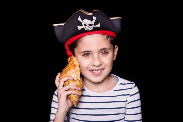 Little boy wearing a pirate costume. Black background.