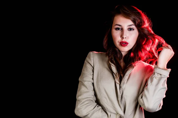 elegant woman on black background with red light. Studio shot. High fashion look.glamour portrait of beautiful sexy young female woman with red lips.