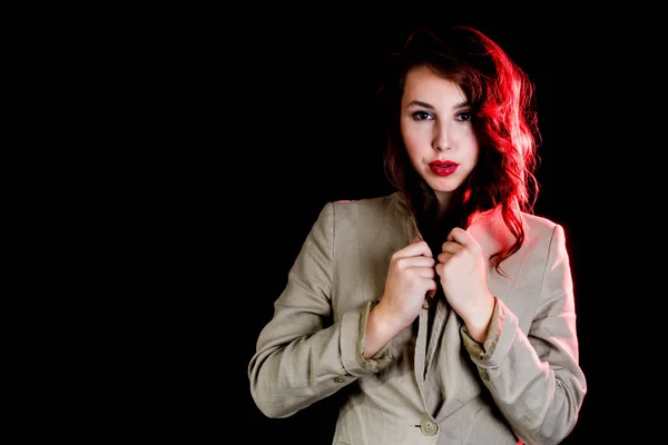 elegant woman on black background with red light. Studio shot. High fashion look.glamour portrait of beautiful sexy young female woman with red lips.