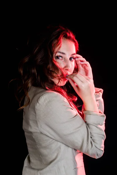 elegant woman on black background with red light. Studio shot. High fashion look.glamour portrait of beautiful sexy young female woman with red lips.