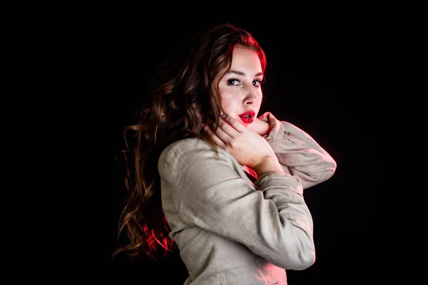 elegant woman on black background with red light. Studio shot. High fashion look.glamour portrait of beautiful sexy young female woman with red lips.