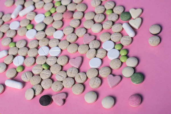 harmaceuticals antibiotics pills medicine /colorful antibacterials pills on pink background /capsule pill medicine. Creative idea. Drugs. Sad. Die. Illness