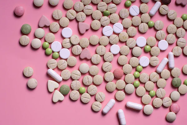 harmaceuticals antibiotics pills medicine /colorful antibacterials pills on pink background /capsule pill medicine. Creative idea. Drugs. Sad. Die. Illness