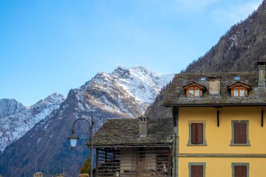 Mountain panorama with peaks, snow, villages, streams and trails near Alagna Valsesia, Italy clipart