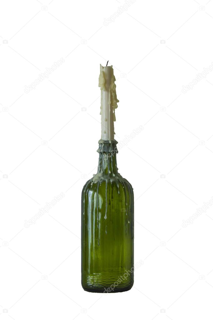 candle in the vintage green bottle isolated on white