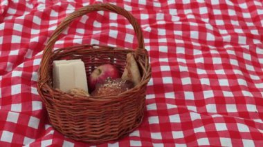 Piknik sepetini süt şişesiyle kapat. Kadın elleri piknik sırasında sepete süt şişesi koyar.