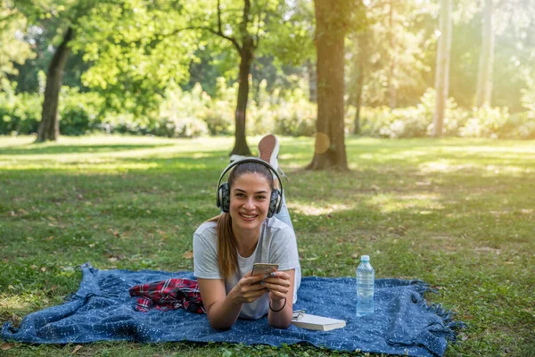 Young Beautiful Happy Girl Lying Park Wireless Headphones Her Head — Stock Photo, Image