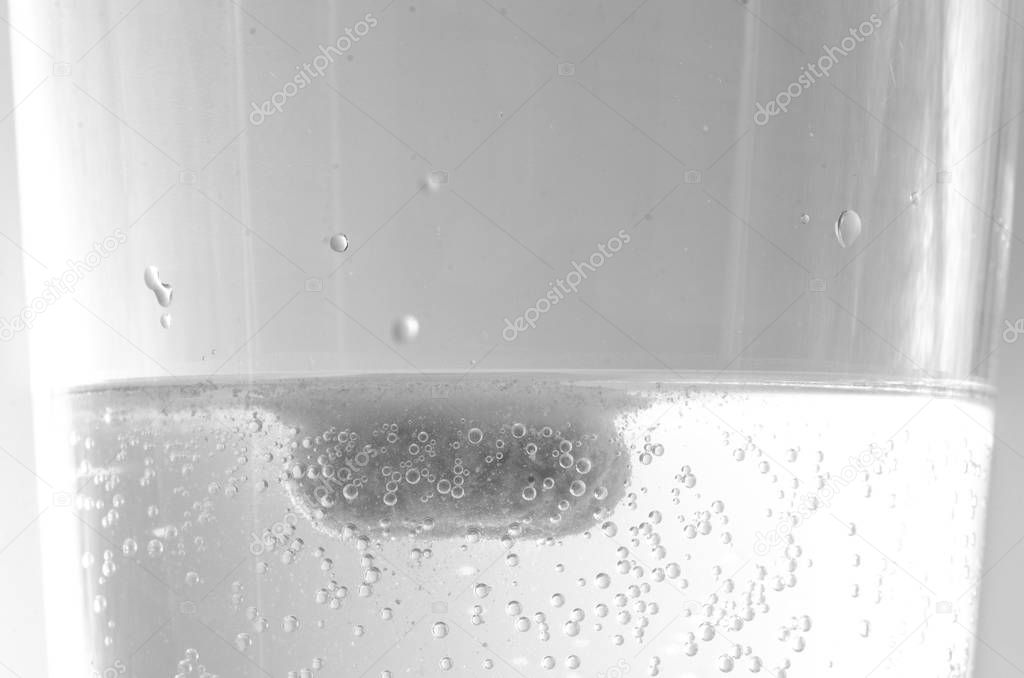Effervescent tablet dissolving in a glass of water