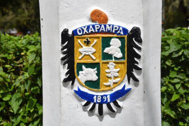 Oxapampa, Peru -The Oxapampa coat of arms painted on a lamp post in the Plaza de Armas clipart