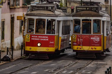 Trams providing mass public transportation in the Alfama district of Lisbon, Portugal clipart