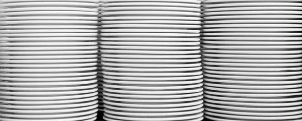 Group of white plates stacked together.