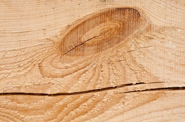 Wood background texture and a knot and a large crack on a plank of natural pine