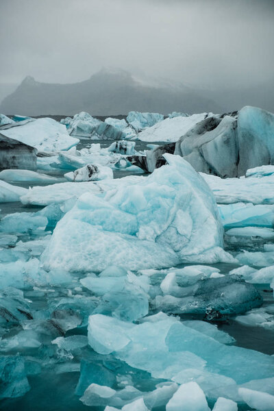 Glacier water covered in ice floes in Nordic landscape in Iceland