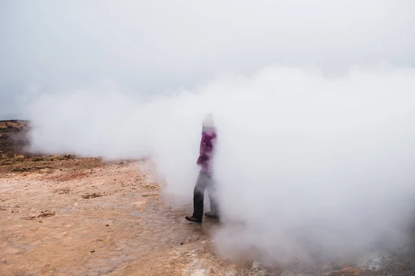 Person in beautiful steaming landscape in Iceland, Europe