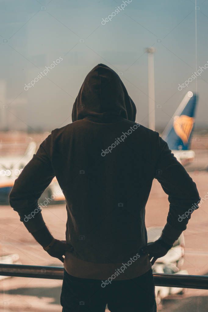 Bologna / Italy - February 10 2018: Angry man looking through airport window (Marconi) on Ryanair airplane during a strike day