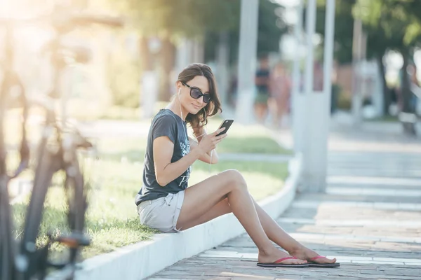 Giovane Donna Seduta Sulla Panchina Con Smartphone Ascoltare Musica Audiolibro — Foto Stock