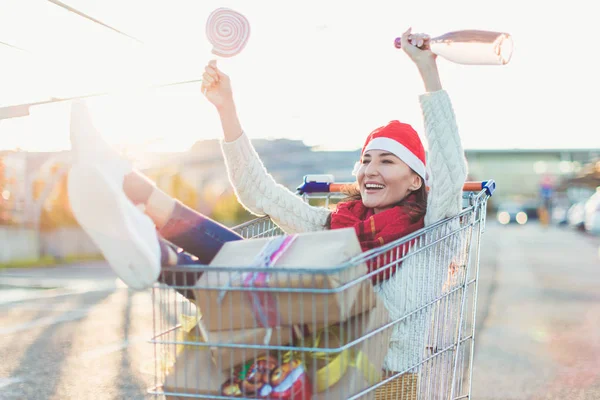 Young Smiling Woman Sitting Shopping Cart Lot Gift Boxes Pink — Stock Photo, Image