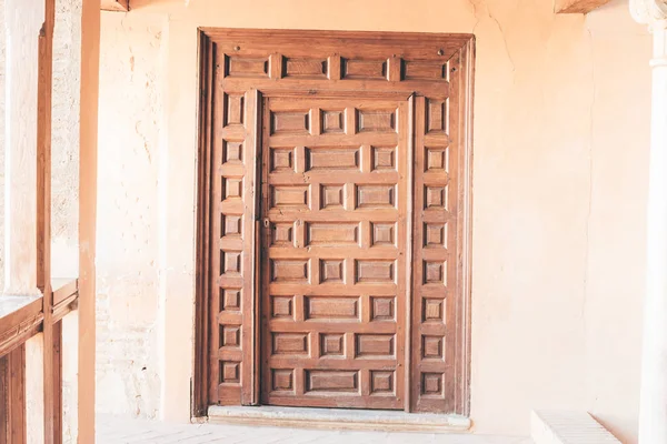 Antique wooden medieval closed door in Arabian castle (Granada, Spain)