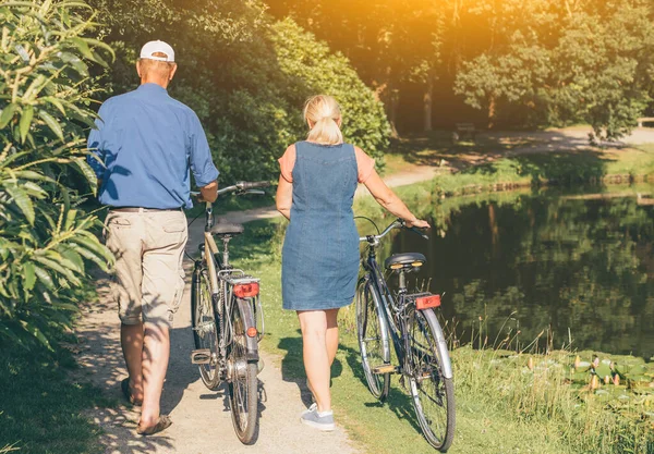 Back View Senior Couple Walking Bicycles Park Sunset Concept Active — Stock Photo, Image