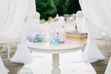 white wooden table and decorations at a wedding ceremony