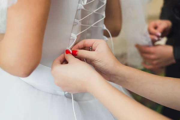 Bridesmaid Tying White Bridal Dresslacing — Stock Photo, Image