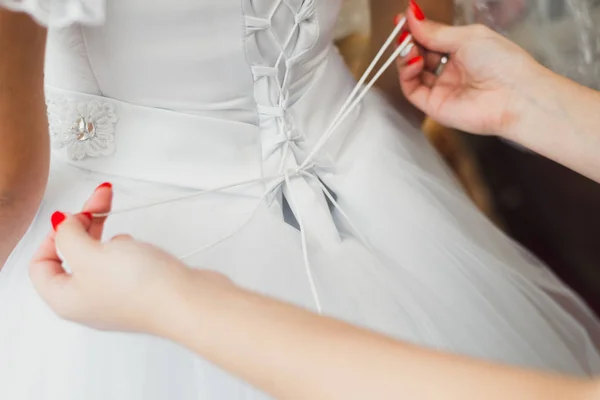 Bridesmaid Tying White Bridal Dress — Stock Photo, Image